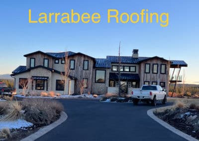 Modern Larrabee Roofing home with wood accents and a scenic driveway.