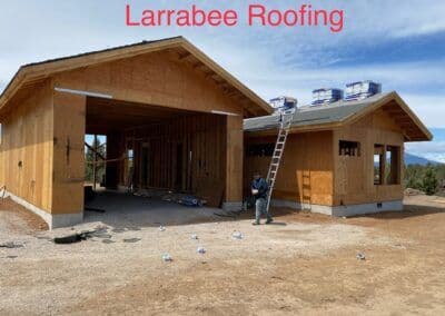Construction site of a wooden home with roofing work by Larrabee Roofing.