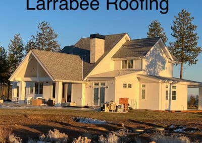 Larrabee Roofing: Modern home exterior with a gray roof and spacious porch in sunlight.
