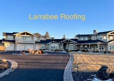 Modern residential home with Larrabee Roofing, clear skies, and landscaped yard.