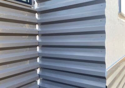 Metal corrugated wall panels showcasing texture and alignment in a modern building design.